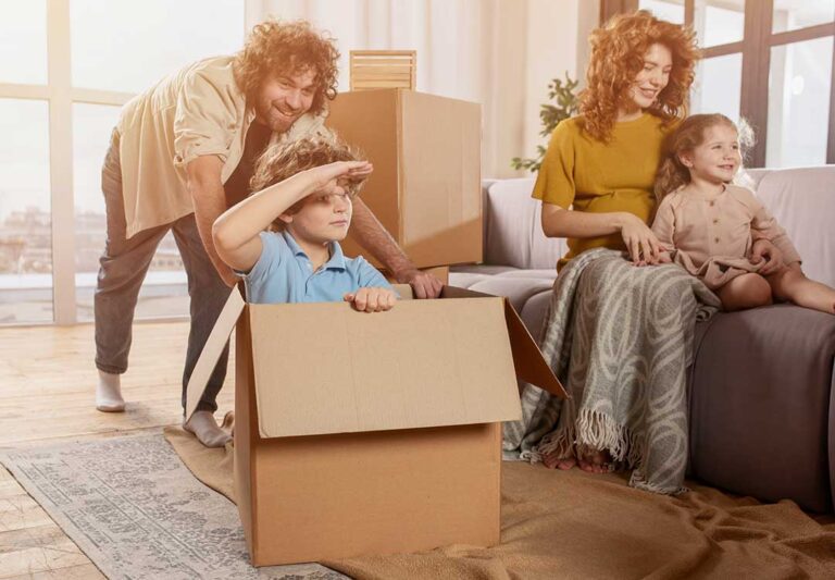 A homeowner removes clutter from a bright living room while organizing furniture and cleaning surfaces.